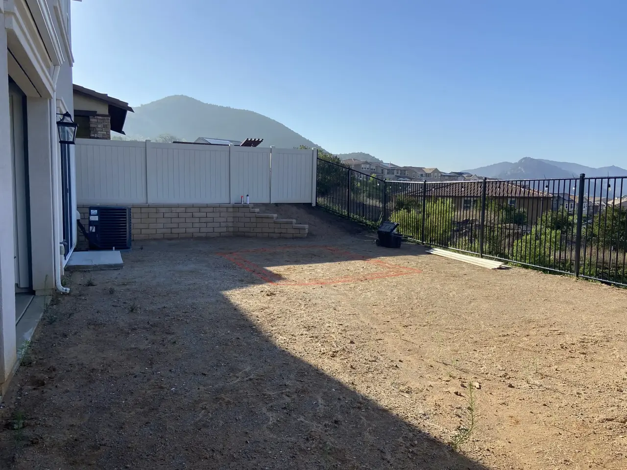a backyard's solid ground preparing the soil for pool construction