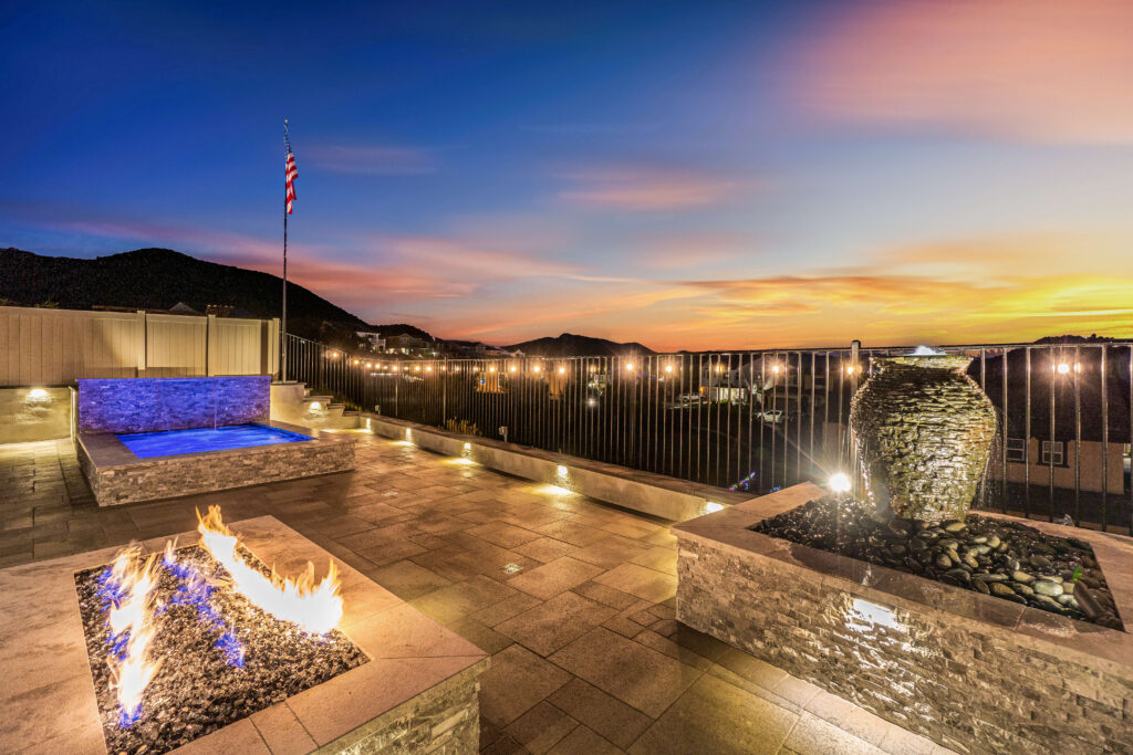 Custom California backyard with fire pit, spa, and sunset view.