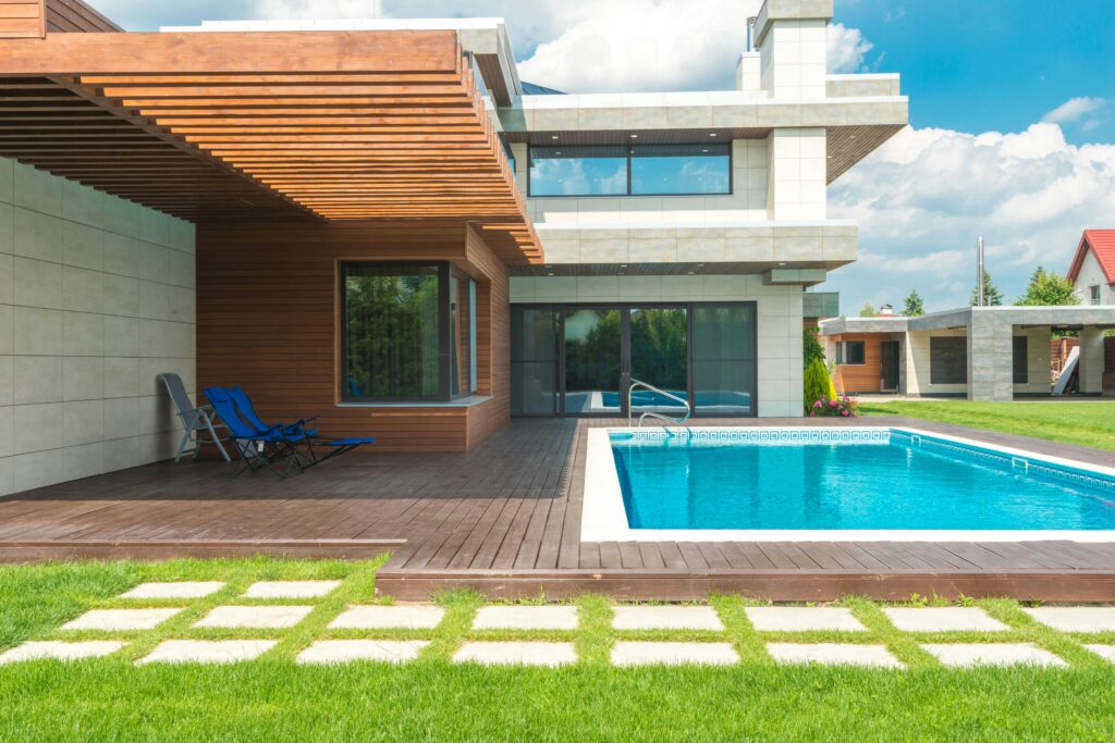 Modern luxury home with wooden deck and swimming pool