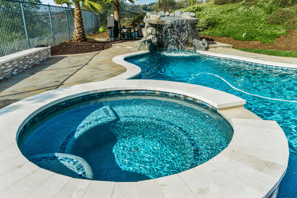 Pool with spa and rock waterfall feature