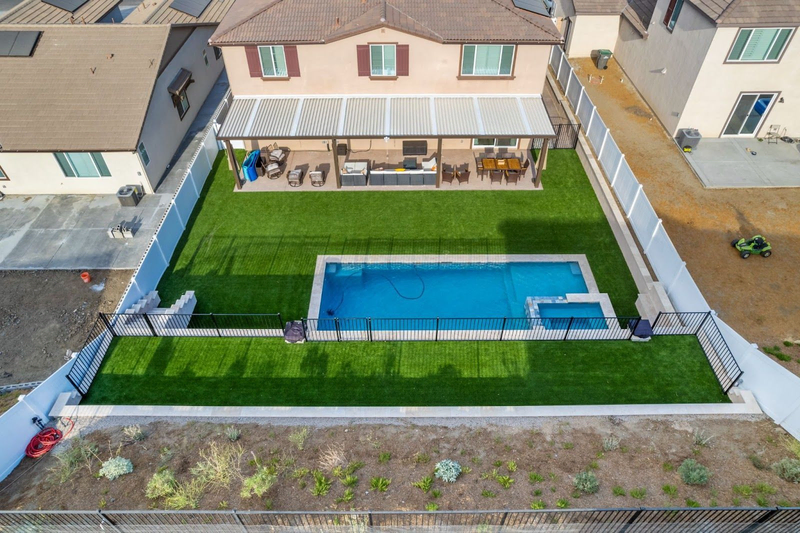 California custom backyard pool with grass and patio