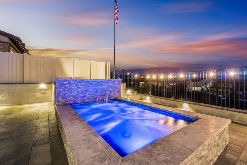 Luxury California custom pool with LED lights at sunset
