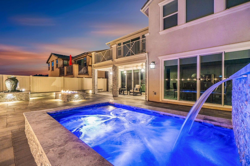 Luxury illuminated spa with waterfall by California Custom Pools