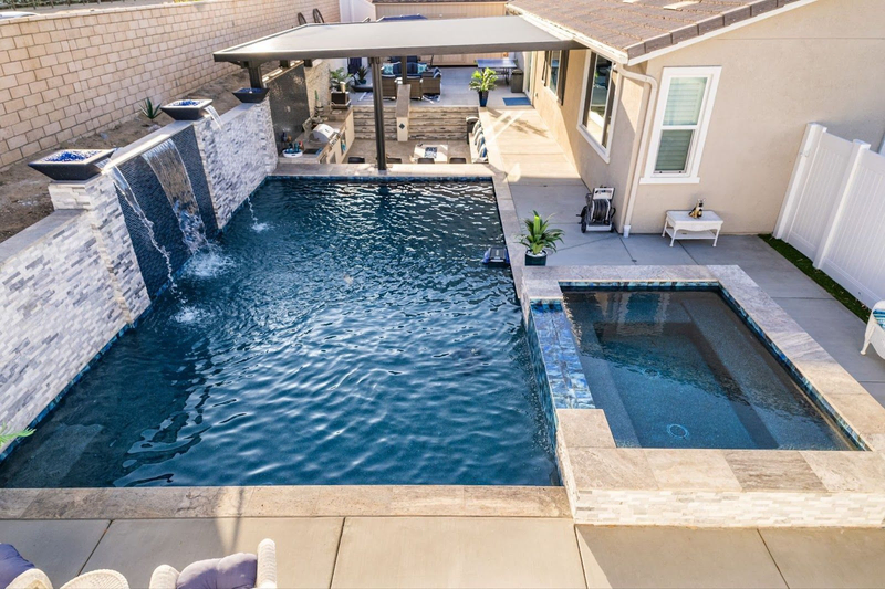 Backyard pool with spa, waterfalls, and covered patio